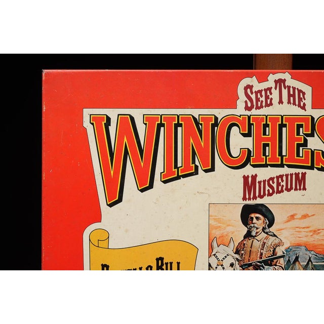 Vintage tin lithograph advertising sign promoting the Winchester Museum at the Buffalo Bill Historical Center in Cody,...