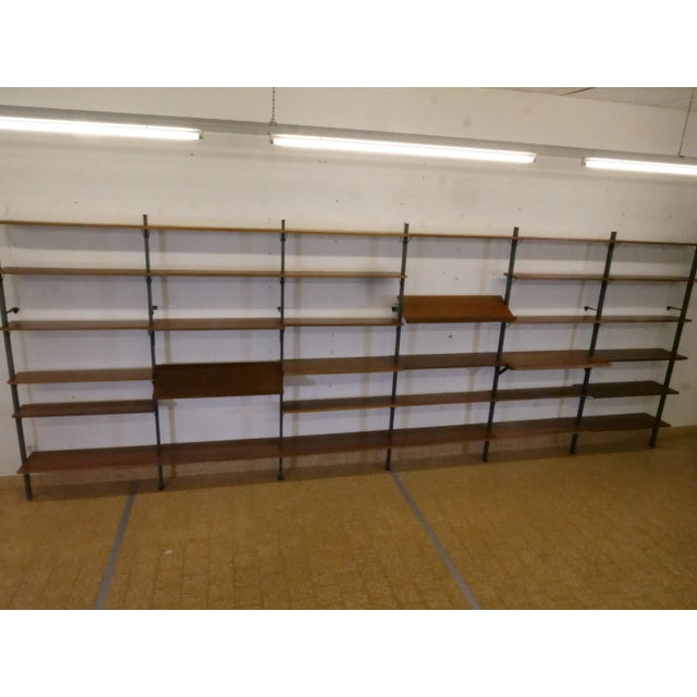 Elegant shelving system made of wood and metal by Olof Pira, Sweden, 1960s. The modular wall system offers numerous design...