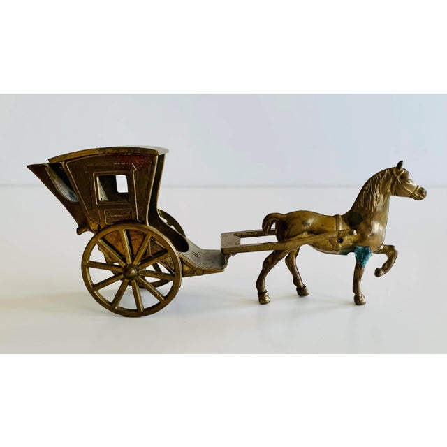 Reminiscent of times gone by this small solid brass horse and carriage would bring attention anywhere it is exhibited in...