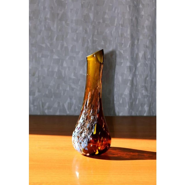 A slender, sculptural studio glass vase by hungarian master glassblower gyula budveszel, dating from the 1990s. The deep...