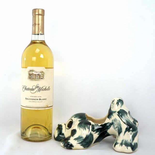 A hand painted planter from the 1950s in the shape of a playful puppy. A molded planter in the shape of a playful puppy...