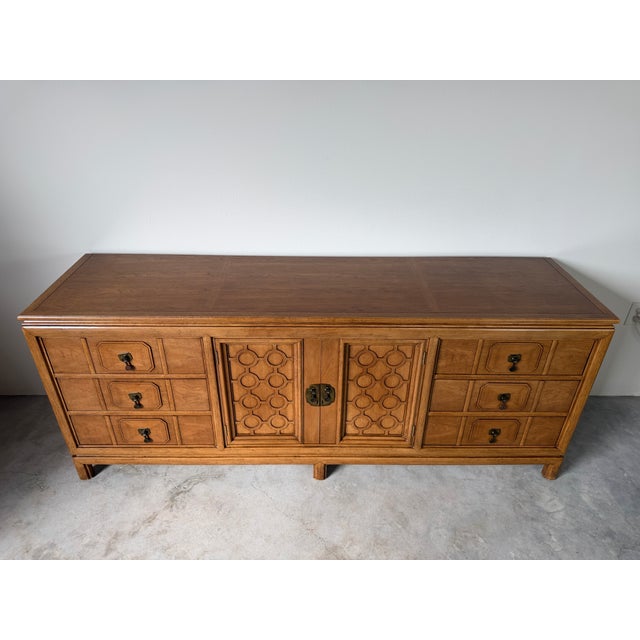 Beautiful vintage Mid Century Thomasville Tamerlane dresser featuring a warm finish, geometric carved cabinet doors,...
