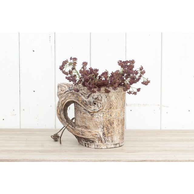 Primitive and beautifully hand-carved wooden milk jug from the tribes of Nagaland. This vessel is adorned with geometric...