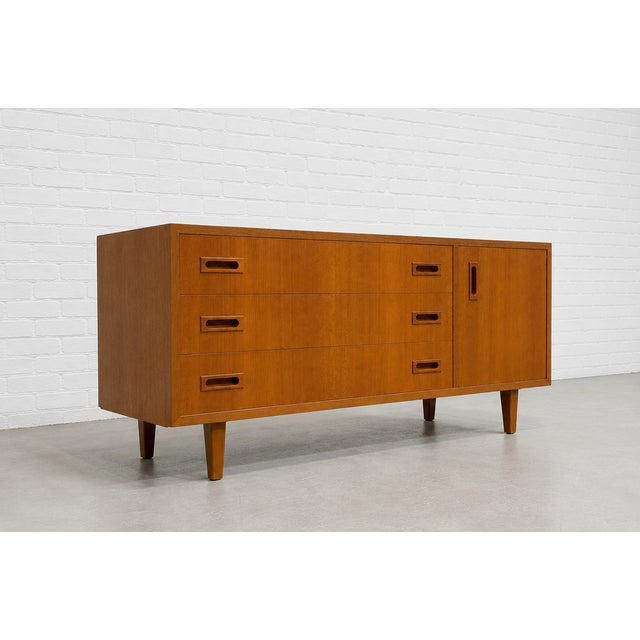 Danish Mid Century Modern teak credenza in a rare low height and perfectly scaled for smaller spaces. This well-crafted...