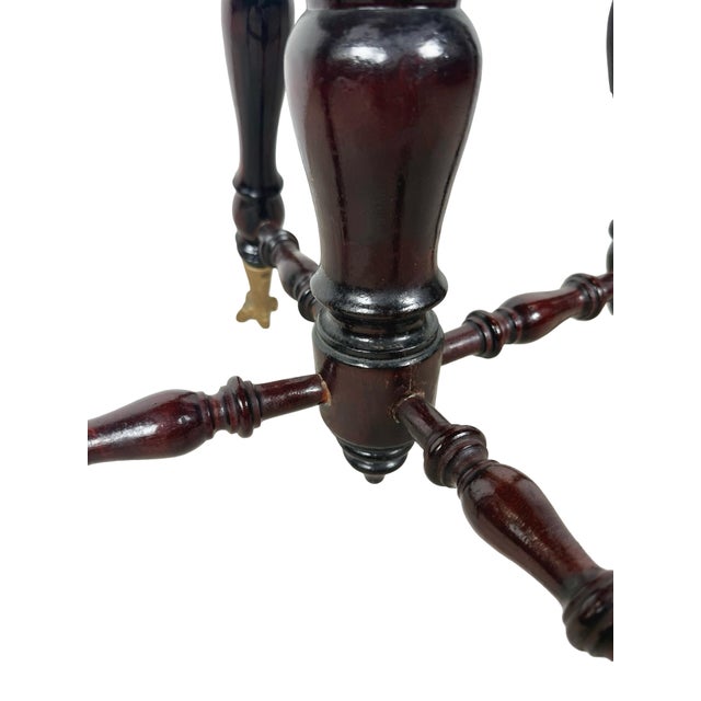 The glass ball feet make this antique piano stool memorable, but there is plenty to appreciate above them. A round wooden...