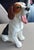 This charming porcelain figurine features a beautifully detailed beagle dog in a playful pose, captured mid-yawn. Crafted...