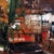 This oil painting captures the vibrant atmosphere of a café interior, with bold strokes and a rich palette of earthy tones...