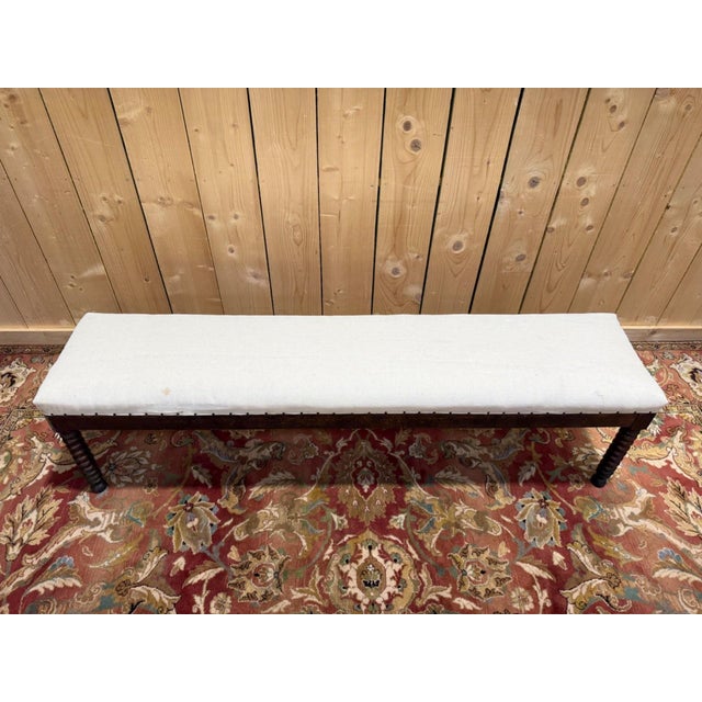 Large, long louis xiii style office bench, 19th century, with six dark solid wood legs turned in a beaded (stacked coil)...