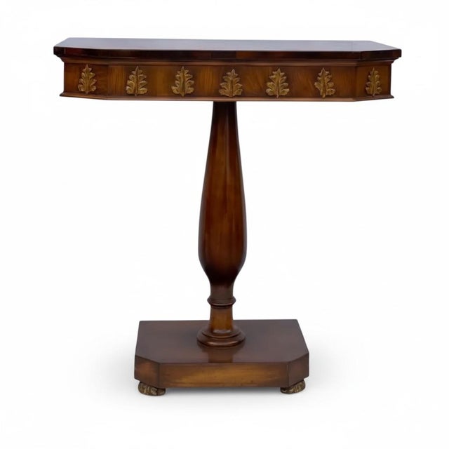 This is a lovely pair of Regency style carved walnut and gilt console tables. The aprons have carved acanthus leaves. The...