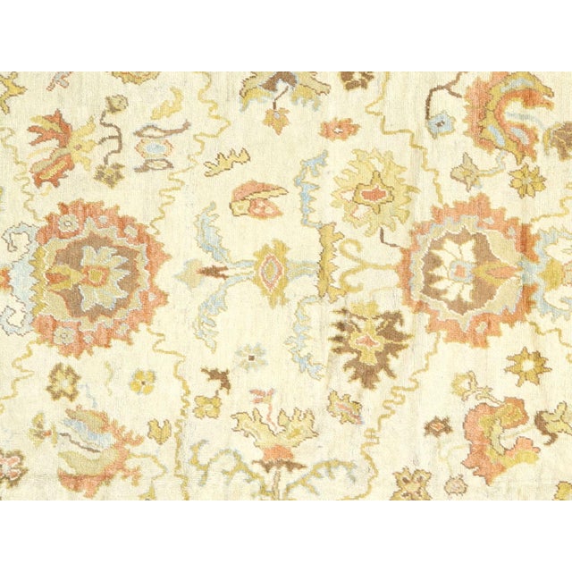 This Antique Turkish Oushak Rug, woven by hand using wool on a wool foundation in the Oushak region of Western Turkey,...