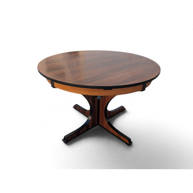 This refined 1960s extendable dining table perfectly embodies the elegance of mid-century design. Crafted from fine Pau...