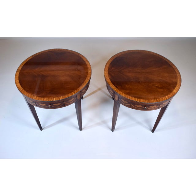 An versatile pair of late 20th-century vintage tables crafted in the classic Federal or Hepplewhite style of rich mahogany...