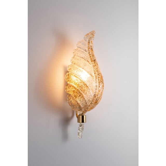 This exquisite wall lamp by Hillebrand features a captivating design with a frosted glass shade shaped like a delicate...