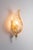 This exquisite wall lamp by Hillebrand features a captivating design with a frosted glass shade shaped like a delicate...