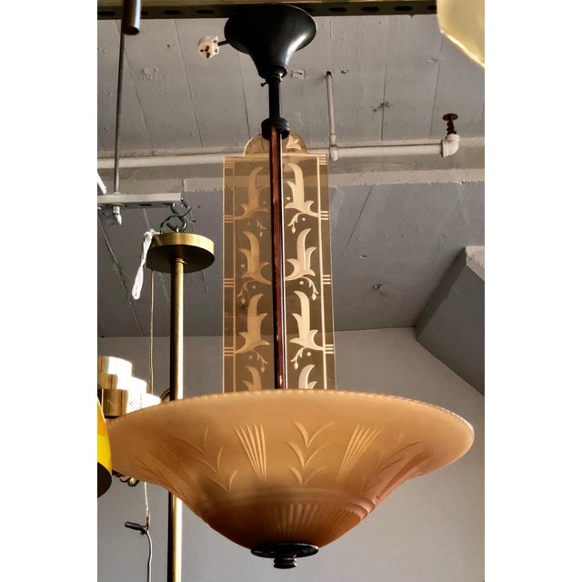 Rare chandelier by Edward Hald, Orrefors, 1930s, patinated brass body, glass plate and four glass pillars in light-orange...