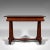 This is an antique console table. An English, rosewood and mahogany side or occasional table, dating to the Regency...
