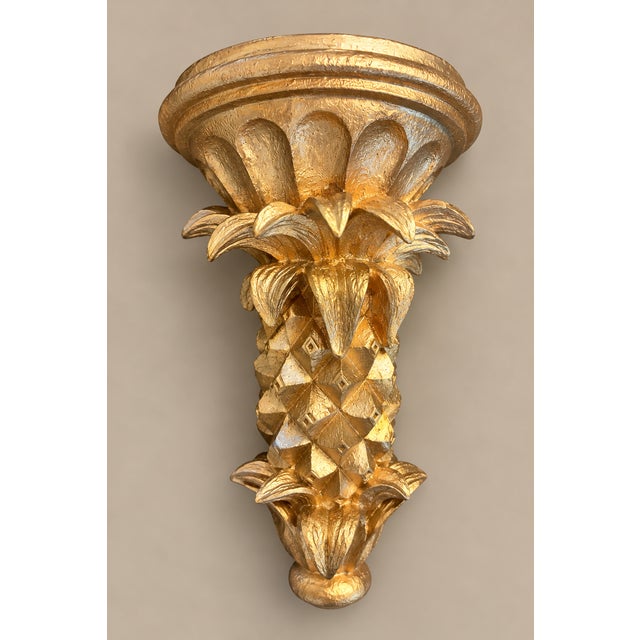A striking decorative wall bracket crafted from plaster and finished in a richly textured gilt finish gold. Featuring an...
