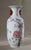 Pansu vase in China porcelain, with closed shape, with reduced mouth, flared lip and flat seat. This vase has a polychrome...