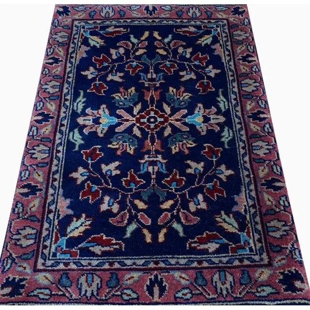 ACTUAL SIZE: 1’4″ x 2’0″ PRIMARY COLOR: Navy / Red AGE: New ORIGIN: India MATERIALS: Wool FOUNDATION: Cotton PRODUCTION:...