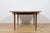 This round extendable dining table was produced by G-Plan in the 1960s. The table has profiled reinforced edges of the...