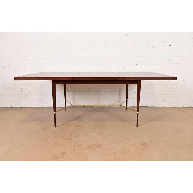 An exceptional Mid-Century Modern extension dining table By Paul McCobb for Directional and produced by Calvin Furniture...
