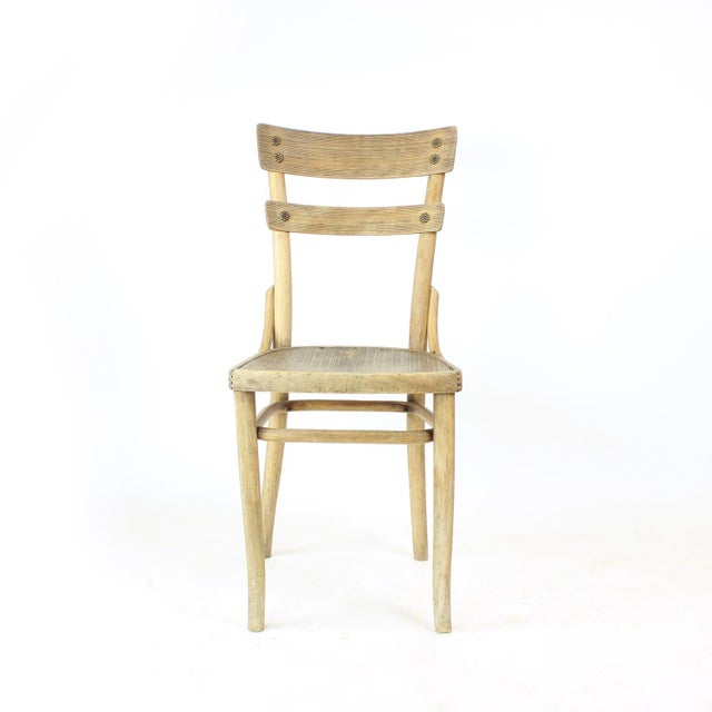 Beautiful vintage dining chair produced by Thonet, retaining its original burned factory stamps and paper label on the...