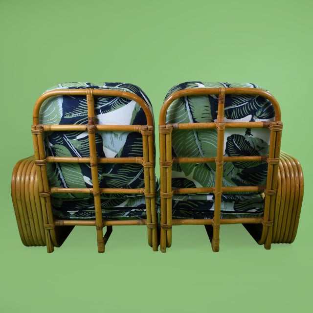 A six-strand loveseat in the style of Paul Frankl, its bent rattan frame built from the thick bundled strands that made...