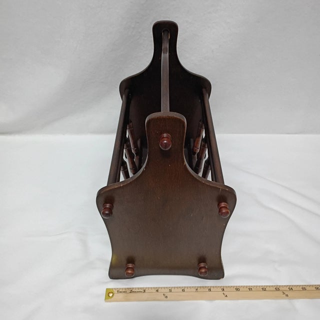 Stylish vintage Mid-Century Modern magazine rack crafted from warm walnut wood, showcasing the clean lines and timeless...