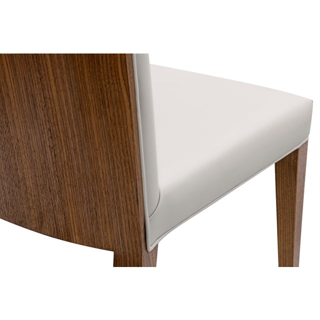 Modern Walnut backed Dining Chair Designed by Greg Sheres. A classic modern high back chair with veneered wood back and...