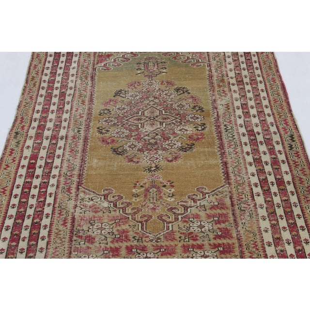 Made with hand-knotted wool in Turkey, this 4x7 antique Ghiordes rug is a rare and exciting new addition to Rug & Kilim’s...