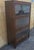 Mid Century Hale Industries Stackable Walnut and Glass Barrister Bookcase Measures 34.25" in width, 13.75" in depth and...