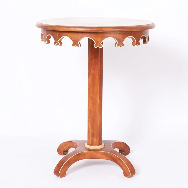 Pair of stylized neoclassic mid-century stands or tables crafted in hardwoods with a mahogany finish having round grain...