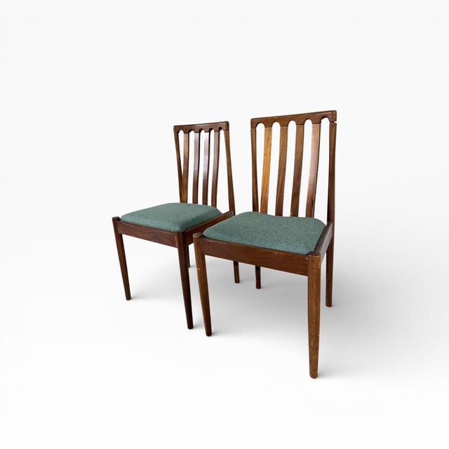 A beautifully proportioned pair of mid-century dining chairs by Meredew, showcasing classic British modern design. Crafted...