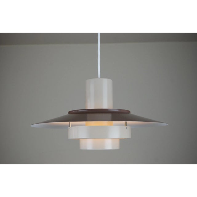 The Falcon ceiling lamp was designed in 1969 by Andreas Hansen for Fog and Mørup, Denmark. It was part of the ‘Regnbue...