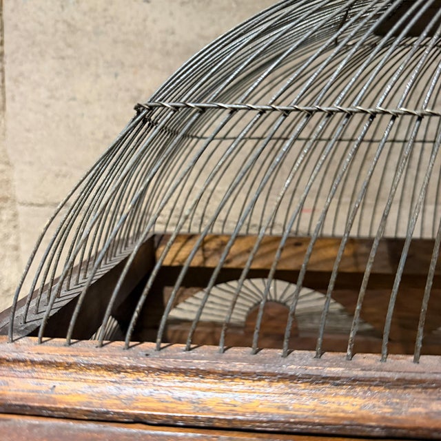 For your consideration, a vintage Victorian architectural-style wooden birdcage, featuring a classic wire dome top and...