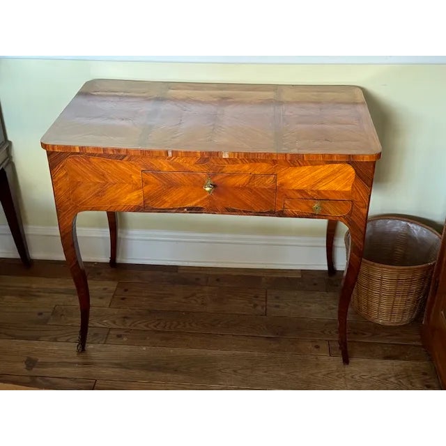 Elegant late-19th-century French Louis XV-style marquetry writing table with beautifully inlaid veneer and graceful...