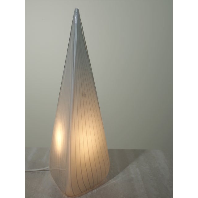Cone-shaped glass lamp with a white striped pattern in Murano glass. with a Vetri Murano authenticity sticker. This piece...