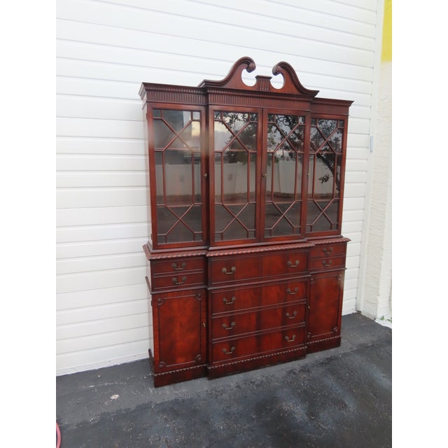 This brilliant Breakfront China Cabinet is made of wood, solid wood, mahogany wood, flame mahogany veneer, and glass. This...