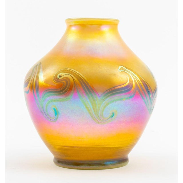 Louis Comfort Tiffany (American, 1848-1933) Reactive Blown Glass Vase, of waisted ovoid form with a subtly toned gold,...
