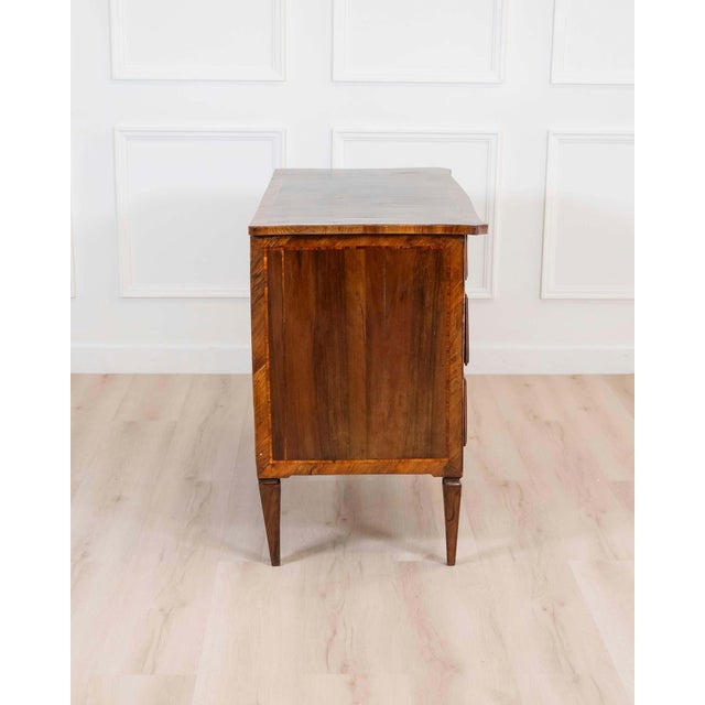 A refined 18th century Emilian Louis XVI chest of drawers in walnut, this elegant piece reflects the sophisticated...