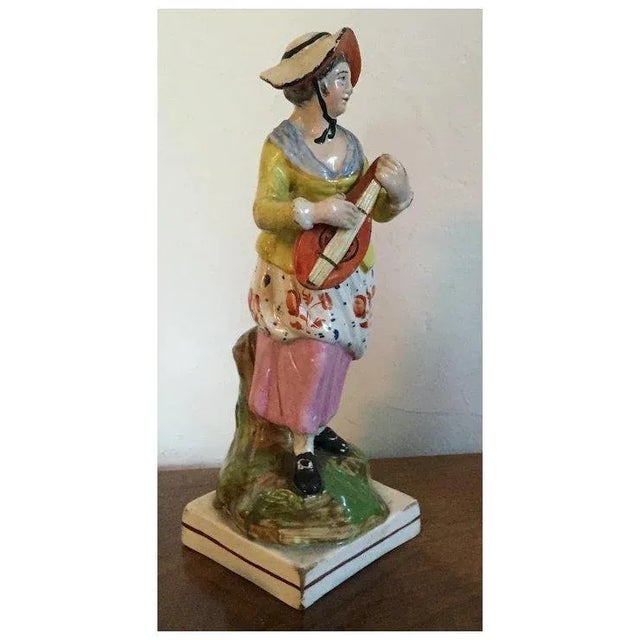 Antique early 19th c. English Staffordshire pearlware figure of a lady musician playing a mandolin. Wonderful detail and...