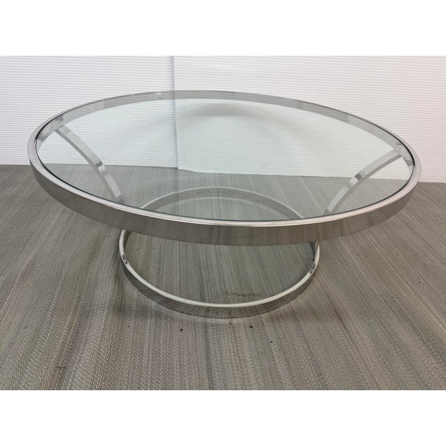 Design Plus Gallery presents a Glass Coffee Table with Chrome Frame. The table has two round circles with the bottom...