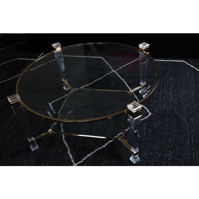 D This stunning Hollywood Regency-style glass coffee table, crafted in 1970s France, is a timeless piece that will elevate...