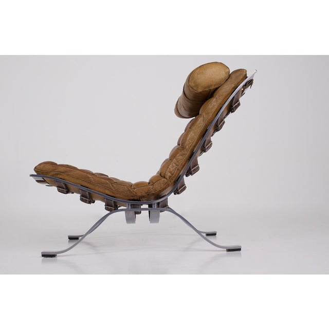 Arne norell (1917-1971) for norell möbel ab, ari armchair and matching ottoman in steel and tan leather, sweden, early...