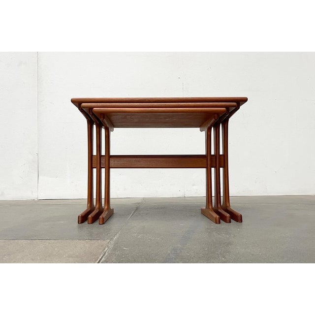 Classic teak nesting tables from Vildbjerg Møbelfabrik. The design is usually attributed to Kai Kristiansen. What is...