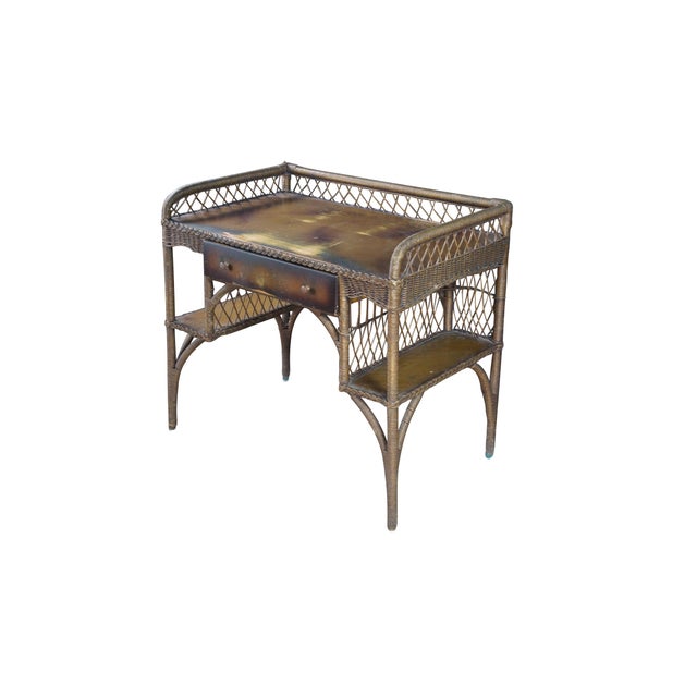 Vintage Heywood Wakefield wicker and rattan writing desk and chair. The desk features rectangular form with one drawer and...