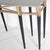 Stunning eight-legged console tables featuring a granite top, a brass band, and blackened wood legs. with their classical...