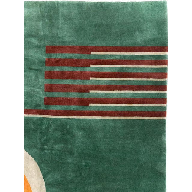 This striking Mid-20th century Chinese Art Deco rug, showcases a bold geometric composition set against a rich green...