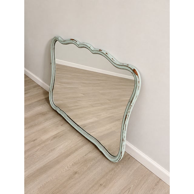 Beautiful vintage French Provincial mirror featuring an elegant scalloped frame refinished in a soft duck egg blue with a...