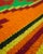 Handwoven wool flatweave area rug (loom-woven), featuring a bold Southwestern / Mexican serape-style geometric design with...